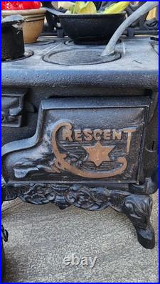 Antique Crescent cast iron large fancy toy stove witha bunch of mini accessories Antique Crescent cast iron large fancy toy stove witha bunch of mini accessories