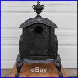 Antique cast iron parlor wood stove by Thomas, Roberts, Stevenson & Co