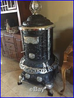 Antique parlor stove Acme cast iron coal or wood burning. Vintage
