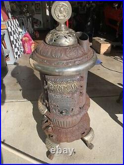 Antique round oak potbelly stove