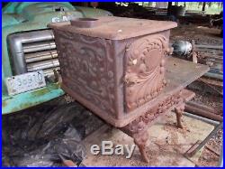 Antique wood cook stove very ornate and all cast iron. Good condition all there
