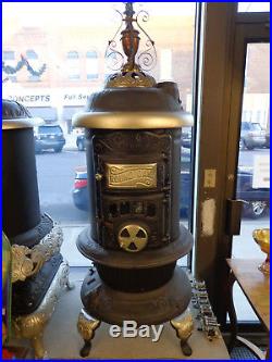 Round Oak antique cast iron stove. Approx. 23L X 23W X 67H