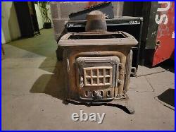 Stout Cast Iron Wood Burning Stove, double burner Chip in the base free standing
