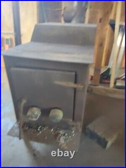 Used freestanding wood stove. For heating with exhaust pipe