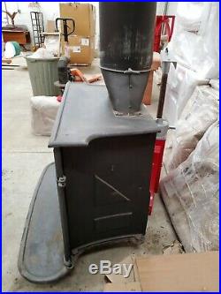 Wood burning heater stove with piping and elevated wood grates