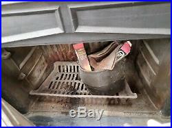 Wood burning heater stove with piping and elevated wood grates